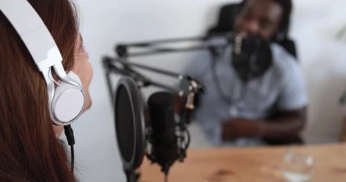 Hosts having podcast session together - Female speaker making an interview during live stream