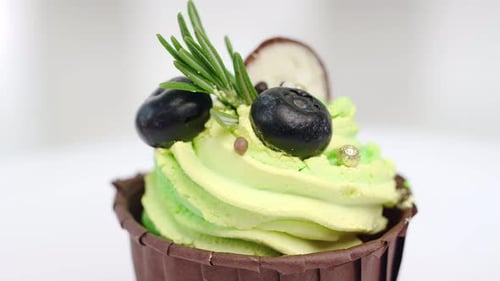 Close Up Macro Muffin with Whipped Cream Decorate By Chocolate and Blueberry