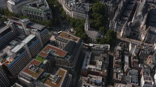 Aerial View of Multistorey Buildings in Town and Traffic in Streets