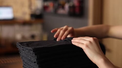 Folding and Stacking Black Cloths Close Up