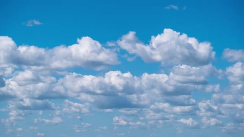 White Cumulus Clouds Drifting in Blue Sky