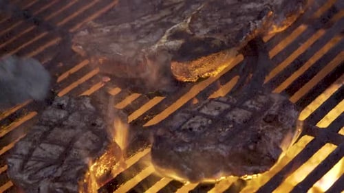 Steaks Sizzling on a Fiery Grill