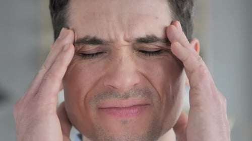 Face Close Up of Young Man with Headache