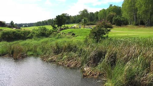 4K Aerial view group of Asian people golfing on at golf course in summer sunny day.