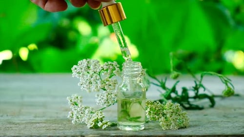 Essential Oil Dropper with Natural Flowers and Greenery