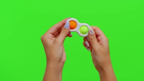 Hands Holding Colorful Silicone Bubbles Sensory Toy Simple Dimple Isolated on Chroma Key Background
