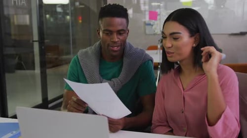 Man and Woman Collaborating in Modern Office