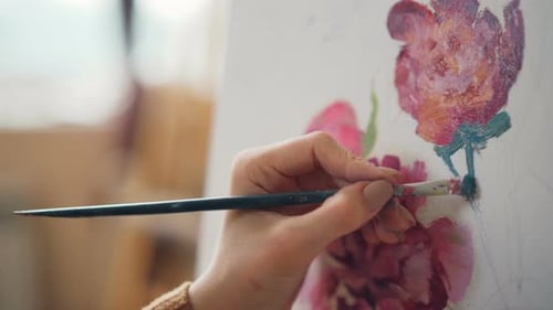 Close-up Shot of Woman's Hand Holding Paintbrush and Mixing Colors on Palette Then Painting Still