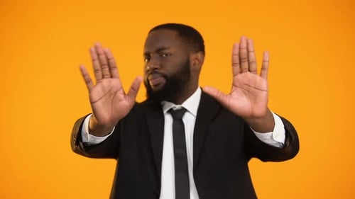 Man in Suit Rejects with Hands Up
