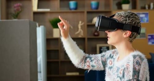 Female executive using virtual reality headset in office 4k