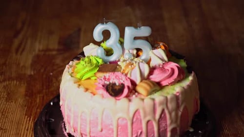 Festive Birthday Cake with Lit Number Candles