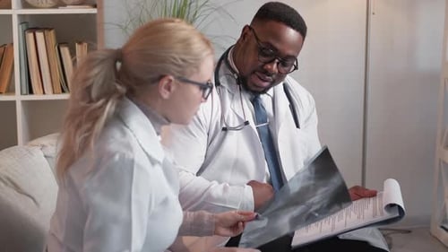 Doctors Reviewing X-Ray and Documents Indoors