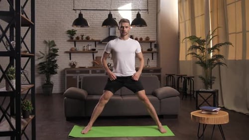 Young Man Doing Yoga Exercise at Home