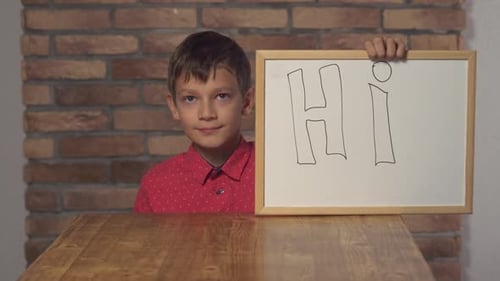 Friendly Boy Holding Hi Sign and Waving