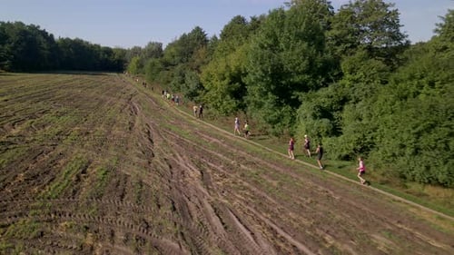 Aerial Shot of People in Trail Running Marathon in a Countryside Field Road, Slow Motion 60 Fps