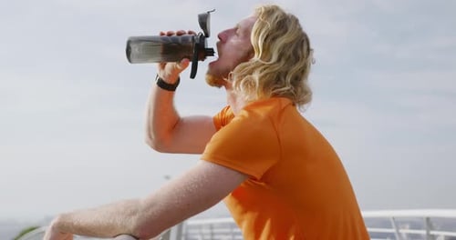 Man Drinking Water From Bottle After Exercising