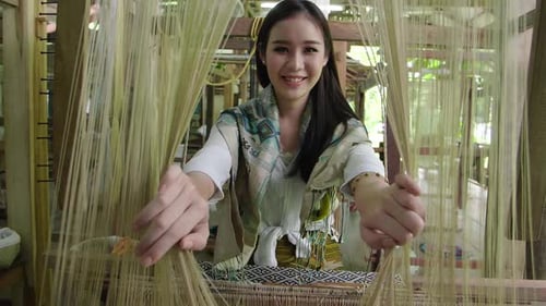 Asian Woman Smiling With Traditional Loom
