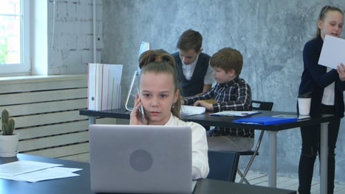 The kids discuss project in office while one business