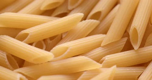 Pile of Uncooked Penne Pasta Close-up