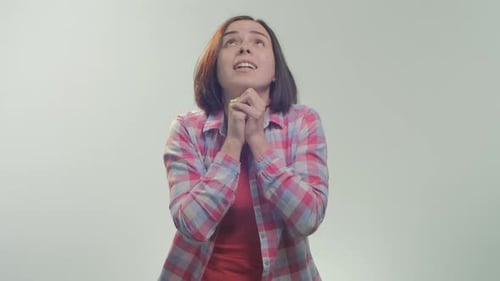 Woman Looking Upwards Clasping Hands in Prayer
