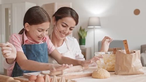 Mother and Daughter Baking Together at Home