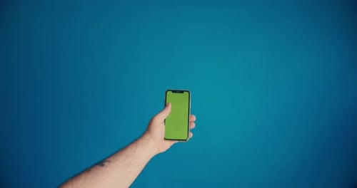 Male Hand Scrolls the Tape on the Smartphone Screen