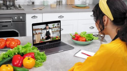 Woman Taking Online Cooking Class in Bright Kitchen