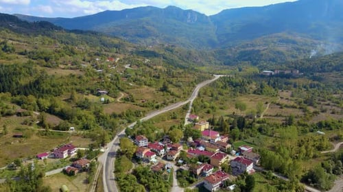 steep green mountains, deep forest and mountain road, beautiful valley and village houses