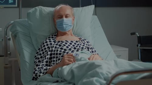 Old Patient with Face Mask and Oximeter