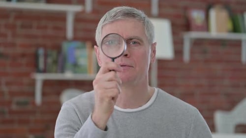 Senior Old Man Searching By Magnifying Glass