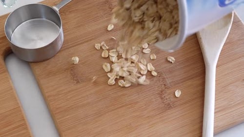Oats Poured on Cutting Board with Spoon and Cup