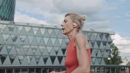 Woman in Activewear Taking Break During Run on City Street