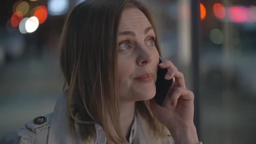 Woman Talking on Mobile Phone at Night