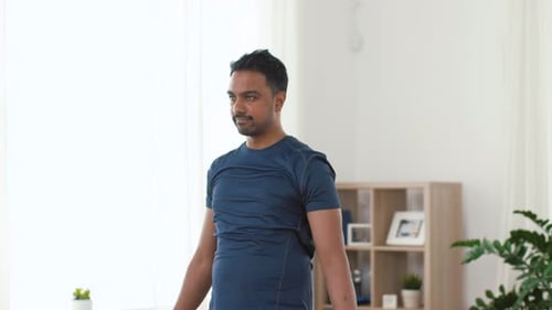 Indian Man Exercising with Dumbbells at Home