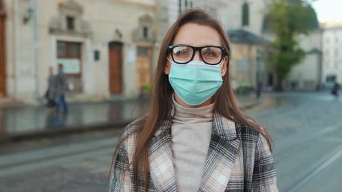 Woman Wearing Face Mask Standing on City Street