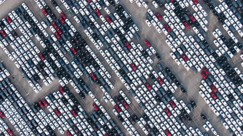 Motion Over Rows of Finished Cars at Open Warehouse Lot