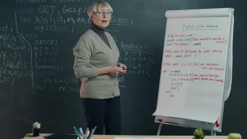 Senior Woman Explains Python Code in Classroom