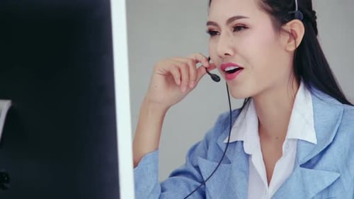 Customer Support Agent or Call Center with Headset Talking to Customer on Phone