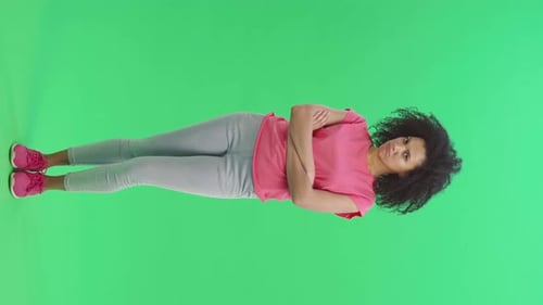 Woman Smiling with Arms Crossed on Green Screen