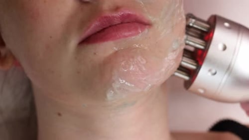 Woman Having Red Light Cosmetology Skin Treatment