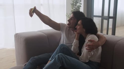 Happy Couple Making Selfie Photo at Home. Smiling Man and Woman Taking Picture