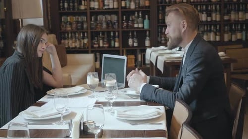 Serious Business Discussion at Restaurant Table