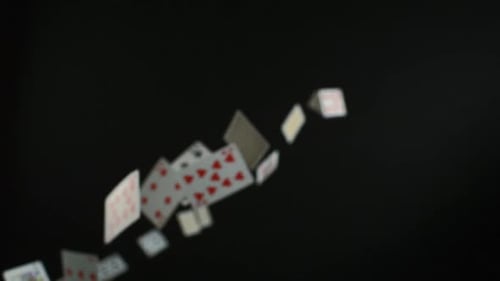 Playing Cards Cascading Against Black Background