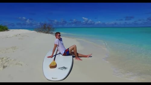 Young couple tanning on paradise sea view beach voyage by clear sea and white sand background of the