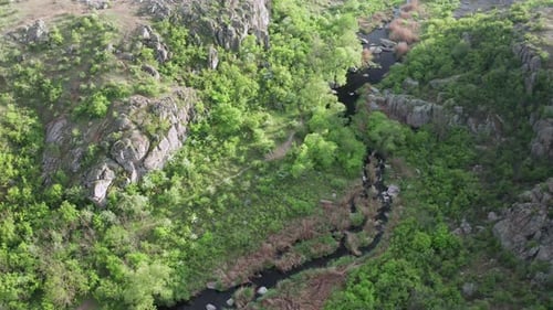 Aerial View of a Stream Running Through a Canyon in the Mountains