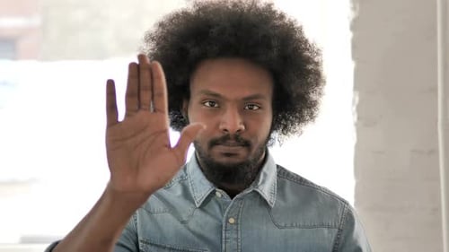 Adult Raises Hand Up Indoors