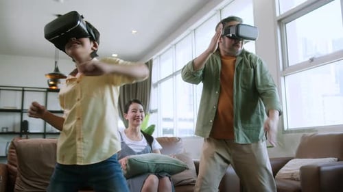 Father and Son Play Virtual Reality Game With Family