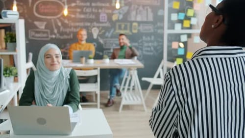 Satisfied Boss Praising Efficient Employees Speaking and Applauding in Creative Office