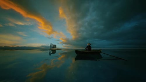 Peaceful Sunset on Water with Lone Boater and Reflections