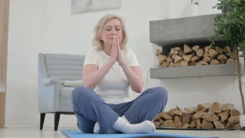 Woman Meditating Indoors on a Yoga Mat